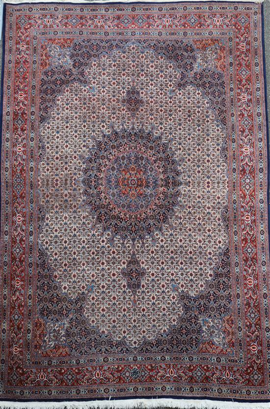 A North West Persian blue ground carpet, 11ft 10in by 8ft 4in.